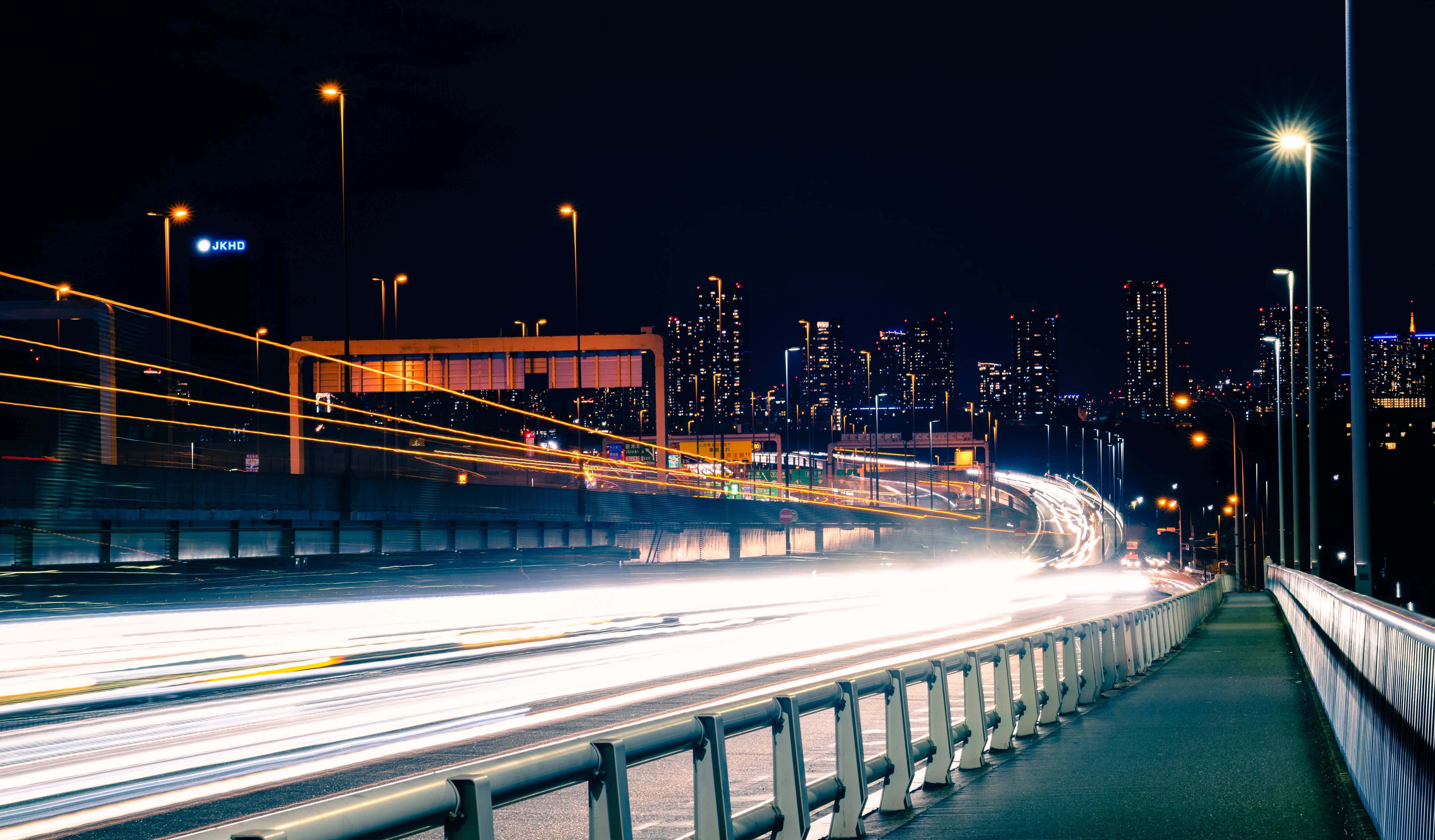 Dynamic Night Highway with Urban Skyline